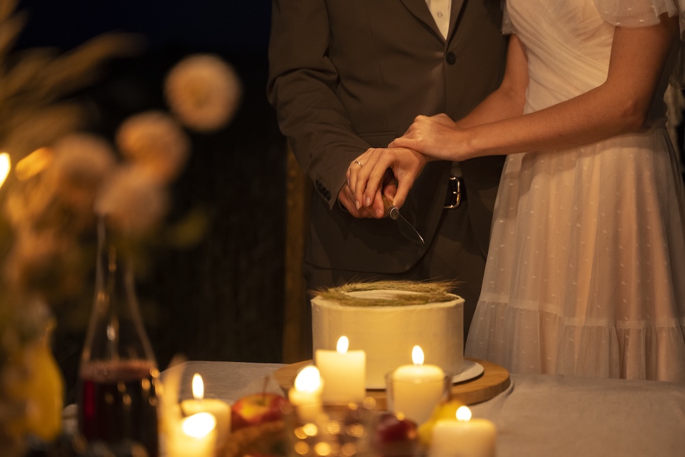 side-view-bride-groom-cutting-cake